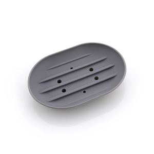 Detail view of grey silicone soap holder showing five drainage slots and nonslip texture