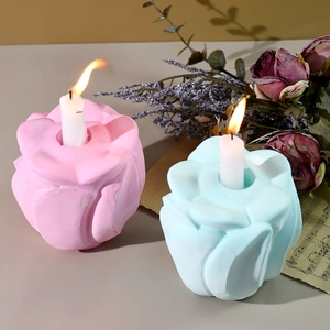 Macro shot of rose-shaped resin silicone molds with realistic petal textures and candle