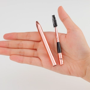 Portable rose gold eyelash brush with protective cap for eyebrow grooming