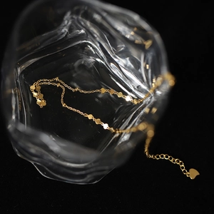 Minimalist 18K gold plated titanium steel heart choker necklace in a glass display