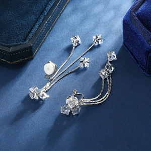 Silver tassel clip-on earrings with square cubic zirconia on a velvet display