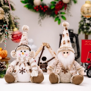 Close-up of knit Christmas plush doll featuring a snowman and gnome with intricate details