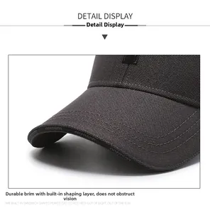 Macro view of the baseball cap brim featuring high-quality stitching and textured fabric