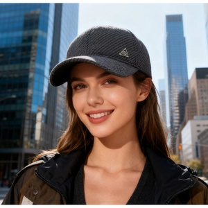 Close-up of dark grey textured winter baseball cap with side logo on a model outdoors