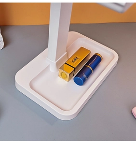 Close-up of a white makeup mirror storage base tray with a convenient lipstick compartment