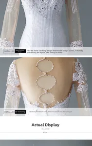 Detail of bridal gown featuring intricate lace sleeves and sequined open-back ring design