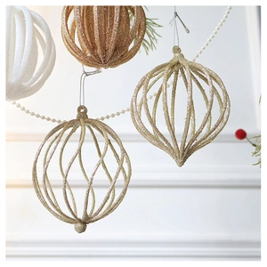 Close-up of glitter champagne hollow geometric Christmas ball hanging with lace details