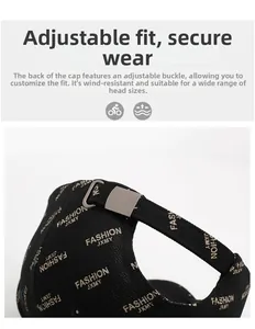Detail of adjustable metal buckle and strap on black baseball cap with letter embroidery