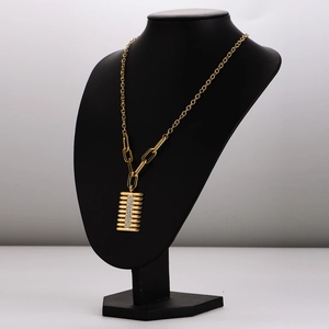 Gold rectangular pendant necklace with vertical crystals on a black bust mannequin