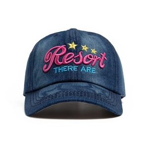 Dark blue denim baseball cap with pink Resort embroidery and stars on a white background