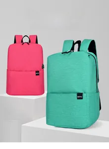 Detail view of the rose red and green lightweight backpacks with integrated USB charging port