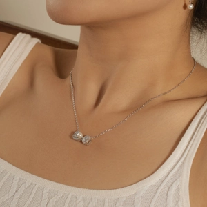 Close-up of S925 silver necklace with zircon bow pendant and white freshwater pearl