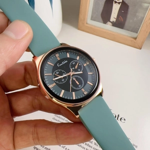 Close-up of rose gold quartz watch with a teal silicone strap and multi-dial face