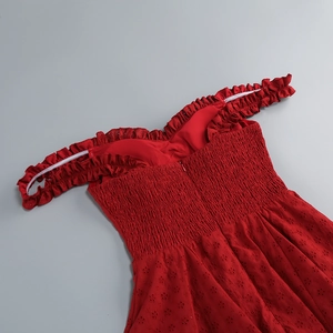 Close-up of red off-shoulder dress with eyelet embroidery and ruched sweetheart neckline