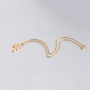 Detailed close-up of golden stainless steel necklace with Africa map pendant design