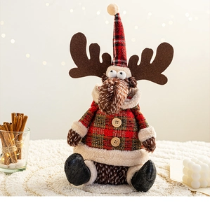 Detailed view of plush Christmas reindeer ornament with red and green plaid fabric design