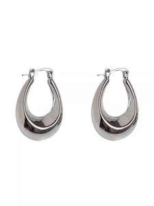 Detail of silver drop-shaped hoop earrings with a polished surface and latch back closure