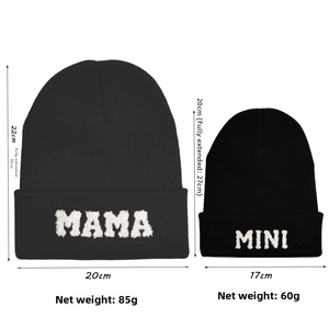 Flat lay of black knit beanie set with MAMA and MINI embroidery and size specifications
