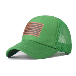 Detail of emerald green mesh trucker hat featuring a US flag faux leather patch