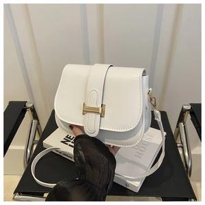 Close-up of white leather square bag featuring a prominent gold H-shaped metal clasp detail