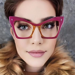 Close-up of pink and tortoise shell oversized cat eye glasses worn by a model