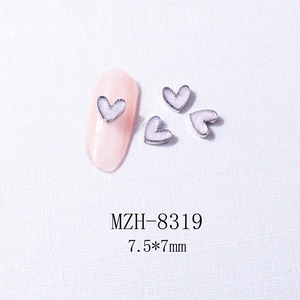 Macro view of lavender heart nail charms with silver metal edges and 7.5x7mm sizing