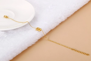 Detail of gold letter S pendant with sparkling rhinestones on a slim elegant chain