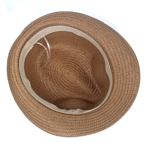 Internal view of brown straw sun hat showing adjustable beige sweatband and weave detail