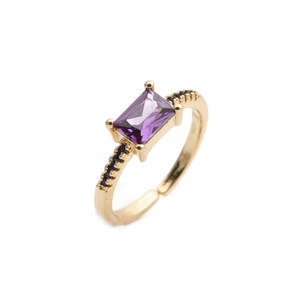 Golden open ring with rectangular purple zircon stone and black crystal accents
