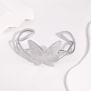 Silver stainless steel open butterfly bracelet with brushed texture on white stone