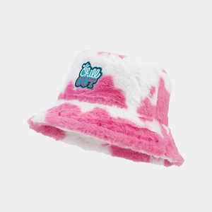 Detail of pink and white cow print plush bucket hat with Chill OUT patch embroidery