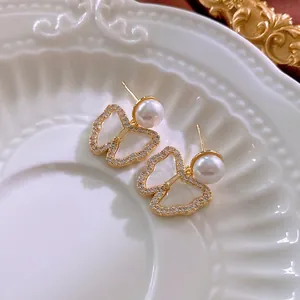 Elegant gold plated butterfly earrings with white pearls and sparkling cubic zirconia stones