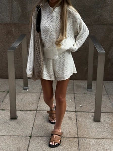 White crochet knit two-piece set featuring a V-neck cardigan and shorts for early autumn