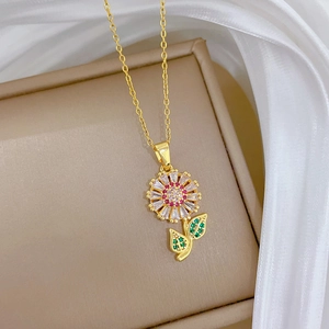 Macro shot of sunflower pendant with pink and white zircon crystals on a gold necklace