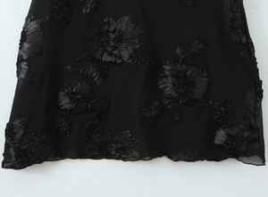 Detail of 3D satin floral appliques on black mesh fabric with exquisite embroidery