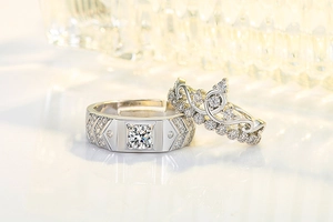 Close-up of crown-shaped moissanite couple rings with sparkling silver finish and pavé setting