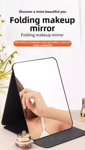 Close-up of black folding HD makeup mirror with adjustable stand and protective cover