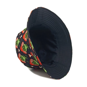 Close-up of navy bucket hat featuring cartoon frog and mushroom pattern with stitching detail