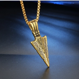 Detailed view of golden stainless steel arrow pendant with retro grainy texture finish