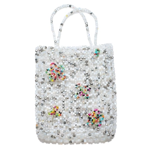 Detail of handmade beaded tote bag with floral patterns and silver mesh structure