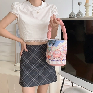 Cute Miffy style canvas bucket bag with pink bubble handle held by a model