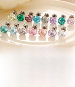 Macro detail of multi-colored 6mm rose cut zircon studs on durable silver titanium steel