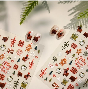 Macro detail of Christmas nail decals featuring sausage dogs, gingerbread men, and bows