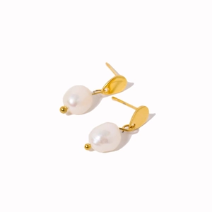 Elegant gold titanium steel earrings with irregular white pearls on a clean background