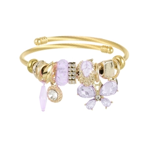 Detail of golden beaded bracelet featuring purple crystal charms and butterfly pendant