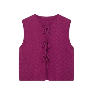 Close-up of plum knit vest featuring V-neck and three front ribbon bow closures