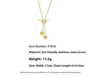 Close-up of heart wing pendant with shimmering cubic zirconia on golden snake chain