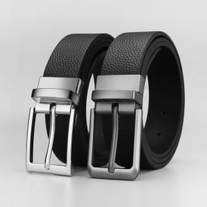 Detail view of men's leather belts with litchi grain texture and square metal pin buckles