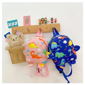 Detail view of pink and blue dinosaur backpacks for kids featuring 3D decorative fins