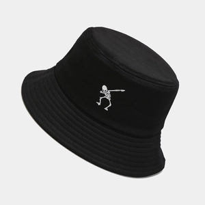 Black bucket hat featuring a white skeleton embroidery in a punk hip-hop street style